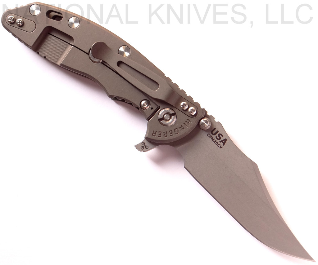 Rick Hinderer Knives XM-18 3.5" Bowie folding knife with thumb stud and flipper tab - shown open lock side.  Working Finish 20CV stainless steel plain edge blade.  OD green - black G-10 handle with Battle Bronze titanium lock side.  Model K2032SGW00.