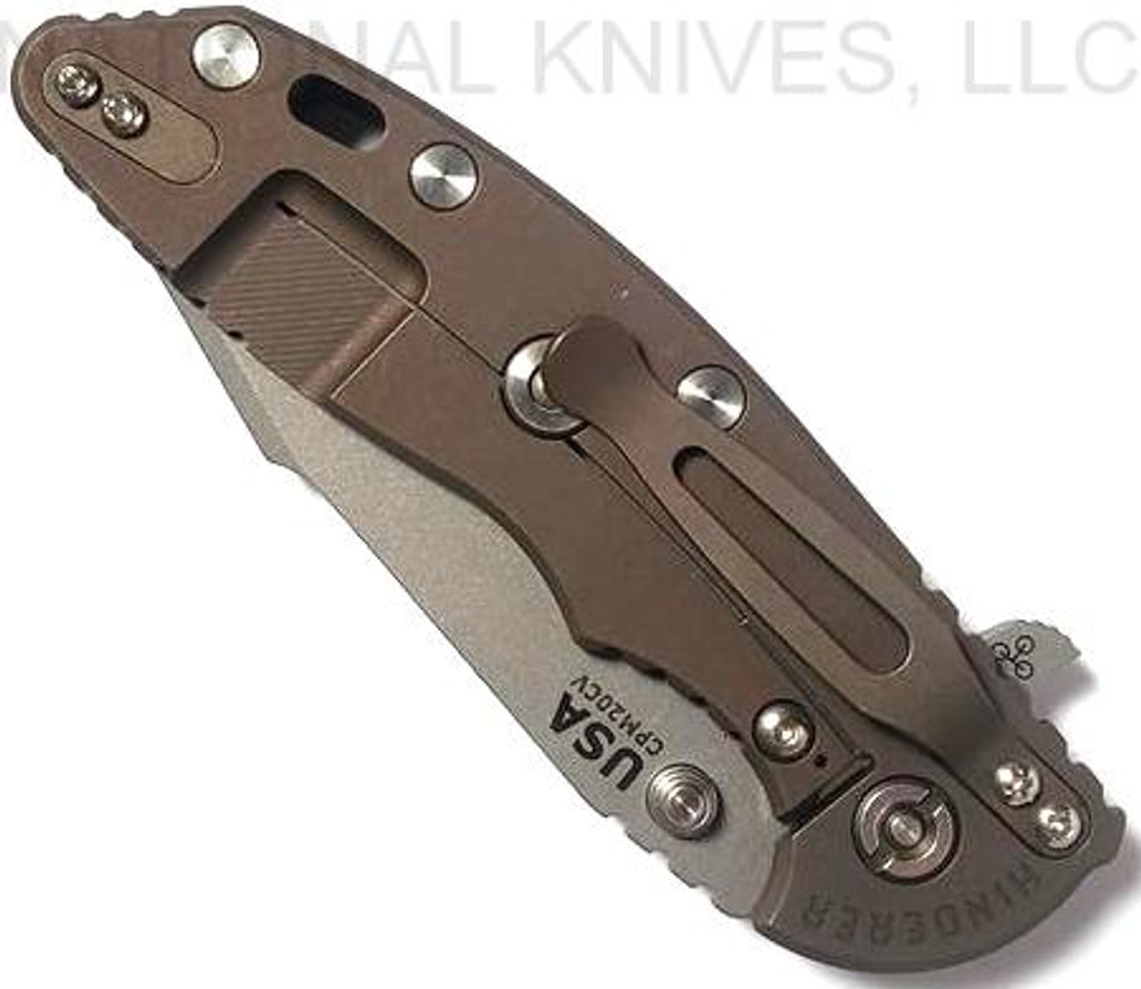 Rick Hinderer Knives Skinny XM-18 3.5" Harpoon Spanto folding knife with thumb stud and flipper tab - shown closed lock side.  Working Finish 20CV stainless steel plain edge blade.  Black G-10 handle with Battle Bronze lock side.  Model K2555SGW00.