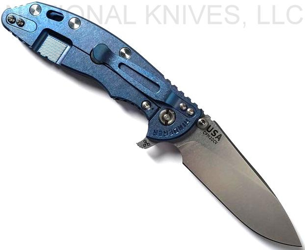 Rick Hinderer Knives XM-18 3.5" Slicer folding knife with thumb stud and flipper tab - shown open lock side.  Stonewash 20CV stainless steel plain edge blade.  Black G-10 handle with stonewash blue titanium lock side.  Model K2012SGS00.