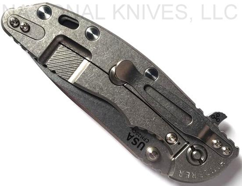 Rick Hinderer Knives XM-18 3.5" Slicer folding knife with thumb stud and flipper tab - shown closed lock side.  Stonewash 20CV stainless steel plain edge blade.  Grey G-10 handle with stonewash titanium lock side.  Model K2012SGS00.