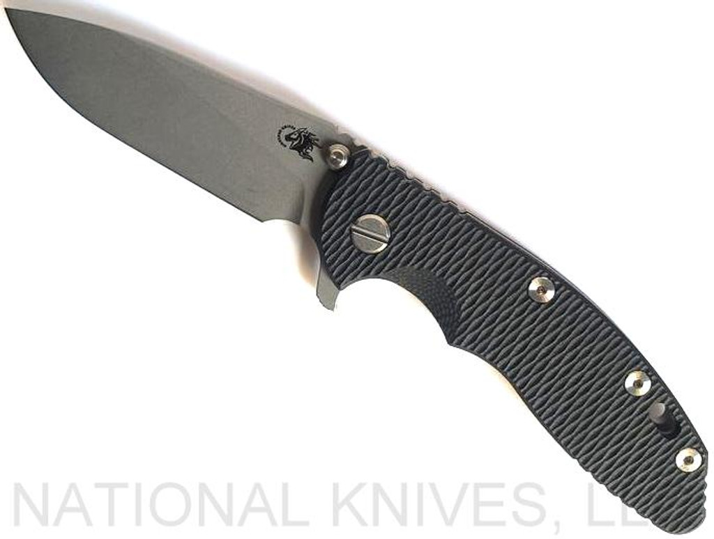 Rick Hinderer Knives XM-18 3.5" Slicer folding knife with thumb stud and flipper tab - shown open presentation side.  Working Finish 20CV stainless steel plain edge blade.  Black G-10 handle with Working Finish lock side.  Model K310102001.