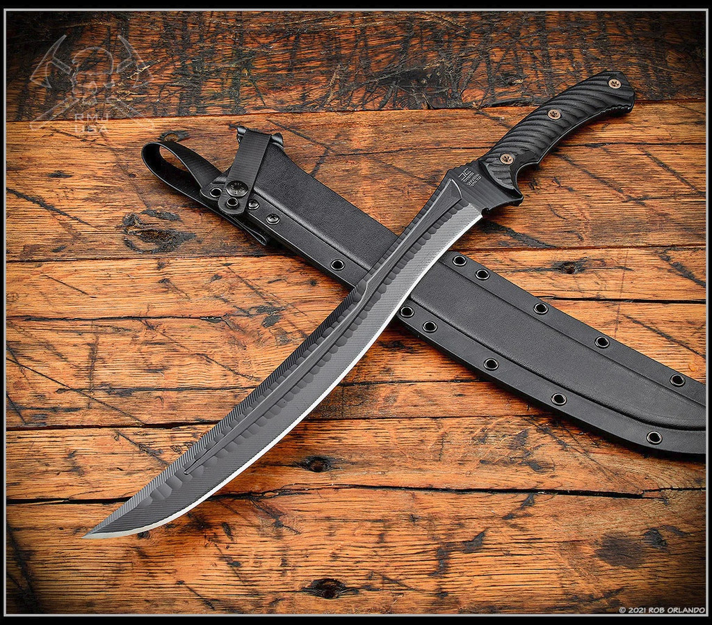 RMJ Tactical Wyvern short sword - shown atop sheath tip pointed lower left.  Textured black 3V steel plain edge blade.  Black G-10 handle scales.  Model 3V-WY-BT-BK.