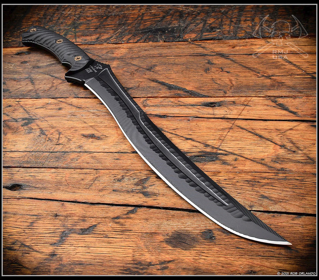 RMJ Tactical Wyvern short sword - shown removed from sheath tip pointed lower right.  Textured black 3V steel plain edge blade.  Black G-10 handle scales.  Model 3V-WY-BT-BK.