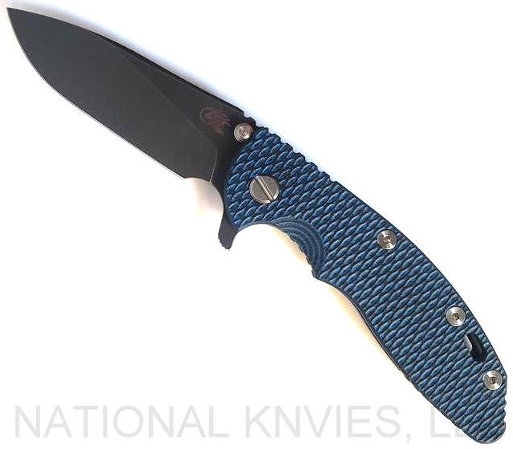Rick Hinderer Knives XM-18 3.5" Slicer folding knife with thumb stud and flipper tab - shown open presentation side.  Battle Black 20CV stainless steel plain edge blade.  Blue - black G-10 handle with Battle Black titanium lock side.  Model K20120SPNC.