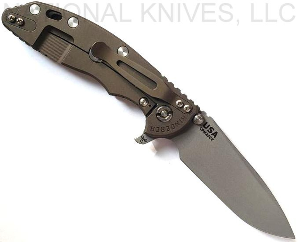 Rick Hinderer Knives XM-18 3.5" Spear Point folding knife with thumb stud and flipper tab - shown open lock side.  Working Finish 20CV stainless steel plain edge blade.  OD green G-10 handle with Battle Bronze lock side.  Model KXM35SPE.