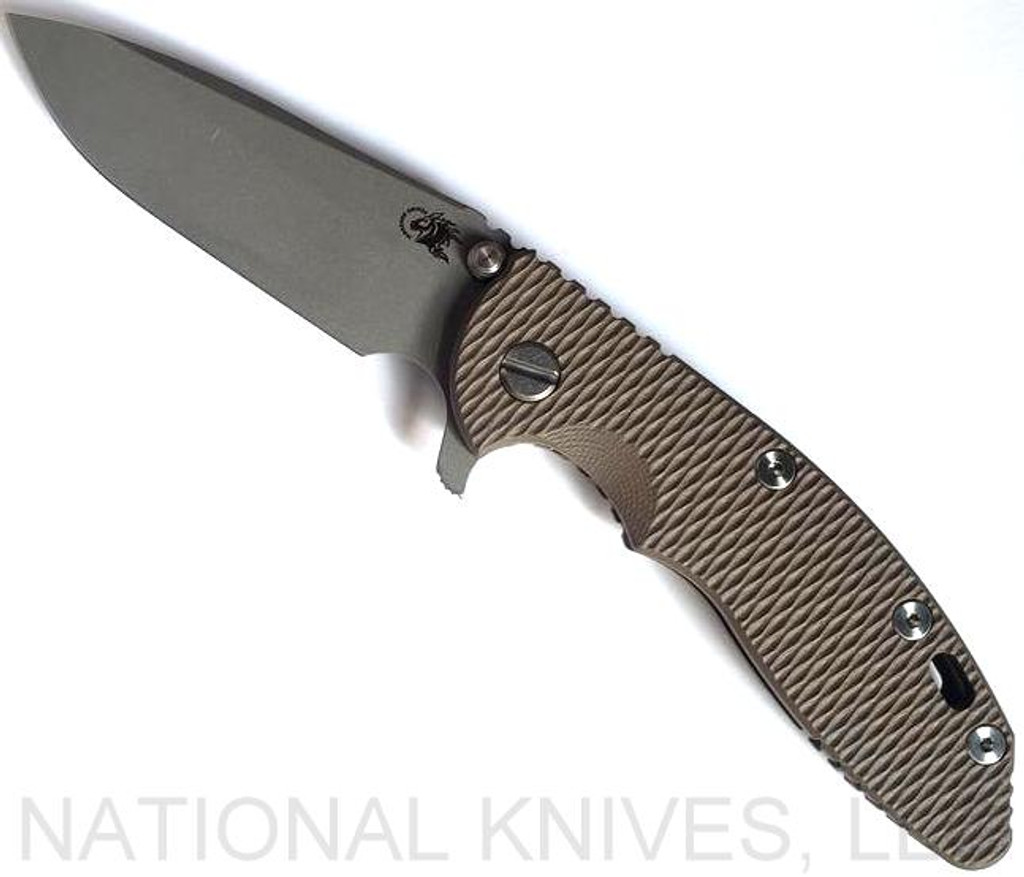 Rick Hinderer Knives XM-18 3.5" Spear Point folding knife with thumb stud and flipper tab - shown open presentation side.  Working Finish 20CV stainless steel plain edge blade.  FDE G-10 handle with Battle Bronze lock side.  Model KXM35SPE.