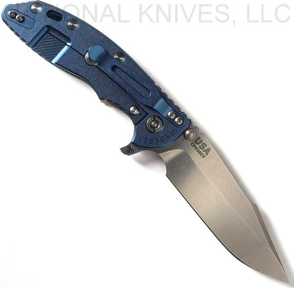 Rick Hinderer Knives Skinny XM-18 3.5" Harpoon Spanto folding knife with thumb stud and flipper tab - shown open lock side.  Stonewash 20CV stainless steel plain edge blade.  Coyote G-10 handle with stonewash blue lock side.  Model KXM35SKHS.