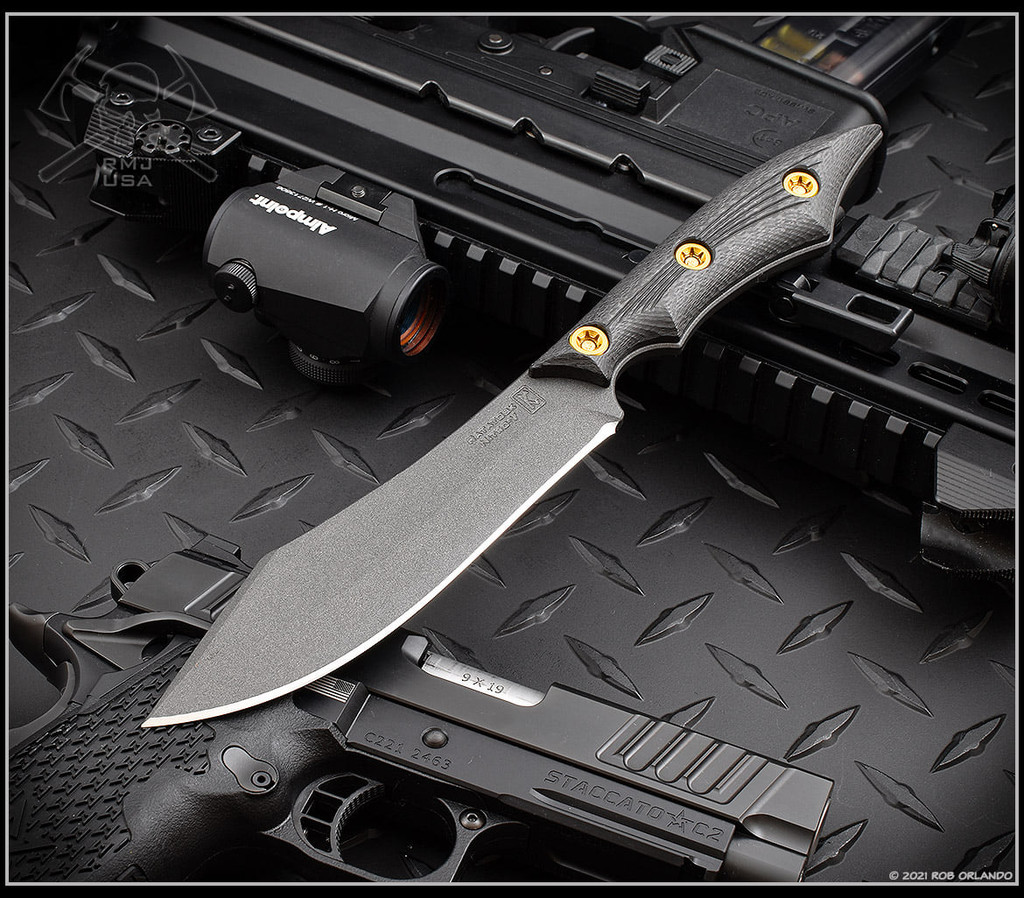 RMJ Tactical Ratatosk fixed blade knife - shown out of sheath reverse.  Cobalt Cerakote Nitro-V stainless steel plain edge blade.  Black carbon fiber handle.