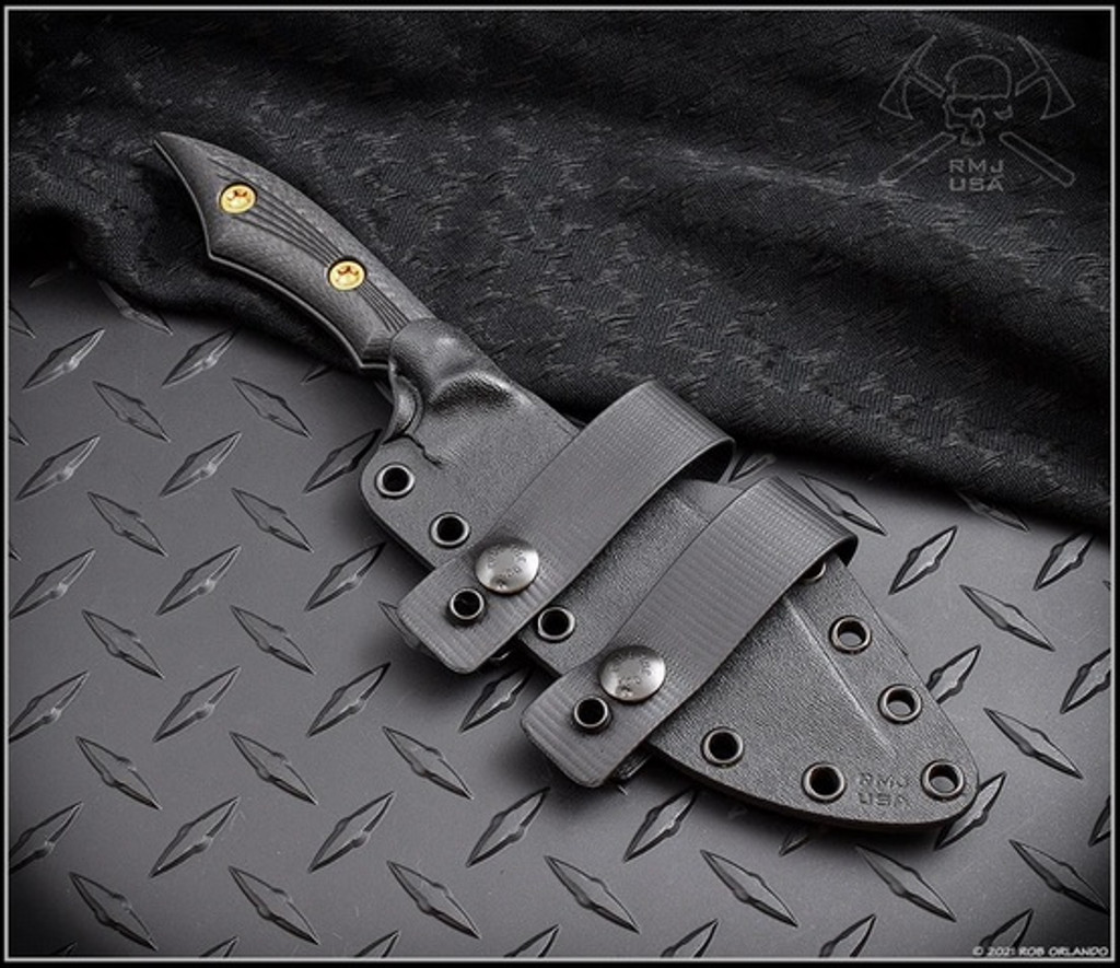 RMJ Tactical Ratatosk fixed blade knife - shown in sheath obverse.  Cobalt Cerakote Nitro-V stainless steel plain edge blade.  Black carbon fiber handle.
