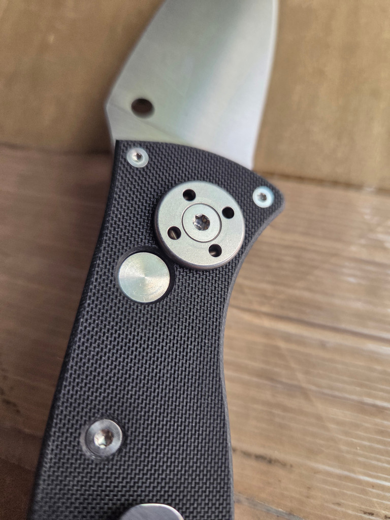 Used Spyderco Autonomy 2 automatic knife with button blade release - close up of pocket clip side pivot shown.  Satin LC200N plain edge blade.  Black G-10 handle.  Model C165GP2.