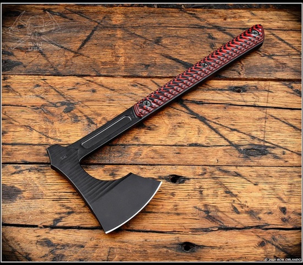 RMJ Tactical 3V Syndicate Raven tomahawk - shown out of sheath reverse.  Textured black Cerakote CPM-3V steel plain edge head.  Black Widow G-10 handle.
For reference only.