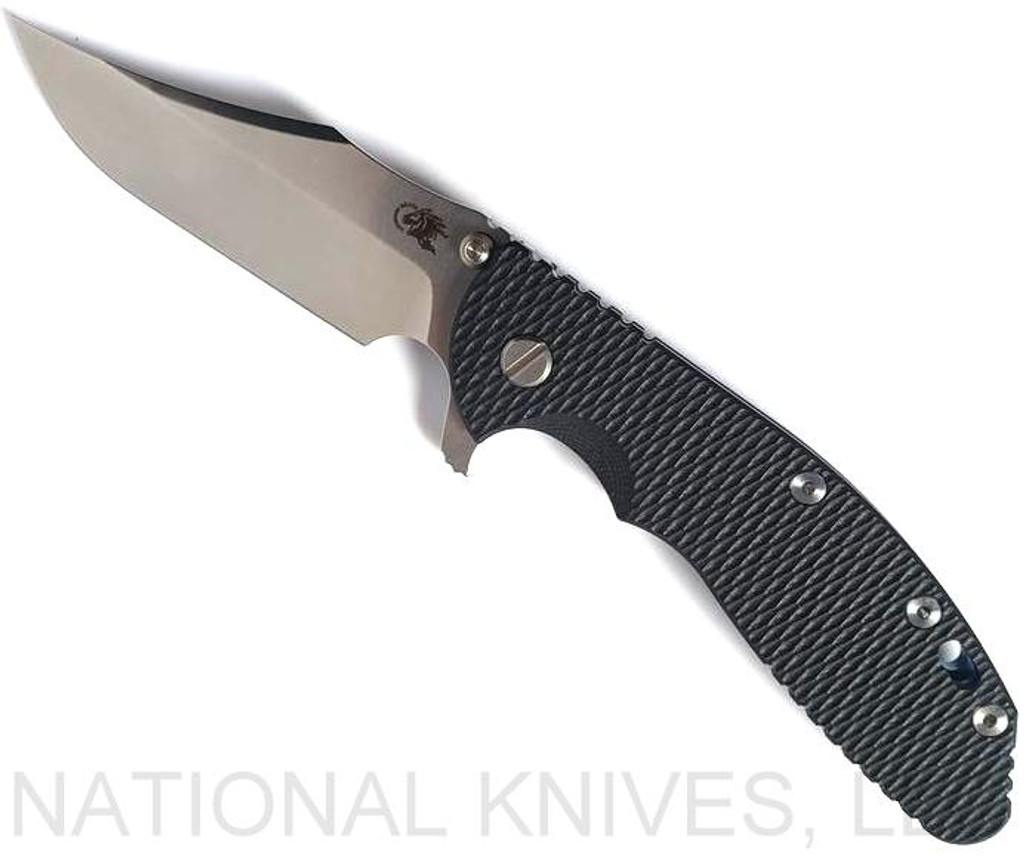 Rick Hinderer Knives XM-24 Bowie folding knife with thumb stud and flipper tab - shown open presentation side.  Stonewash 20CV stainless steel plain edge blade.  Black G-10 handle with stonewash blue lock side.  Model KXM40BO.