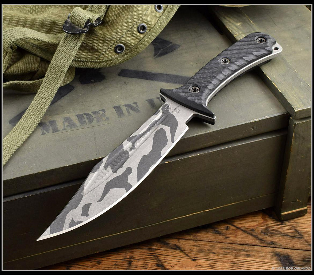 RMJ Tactical National Knives, LLC Exclusive 3V Syndicate Jungle Combat fixed blade knife - shown out of sheath reverse.  Urban Camo colored 3V steel plain edge blade.  Black G-10 handle.  Model K-JC-3V-UC.
For reference only.