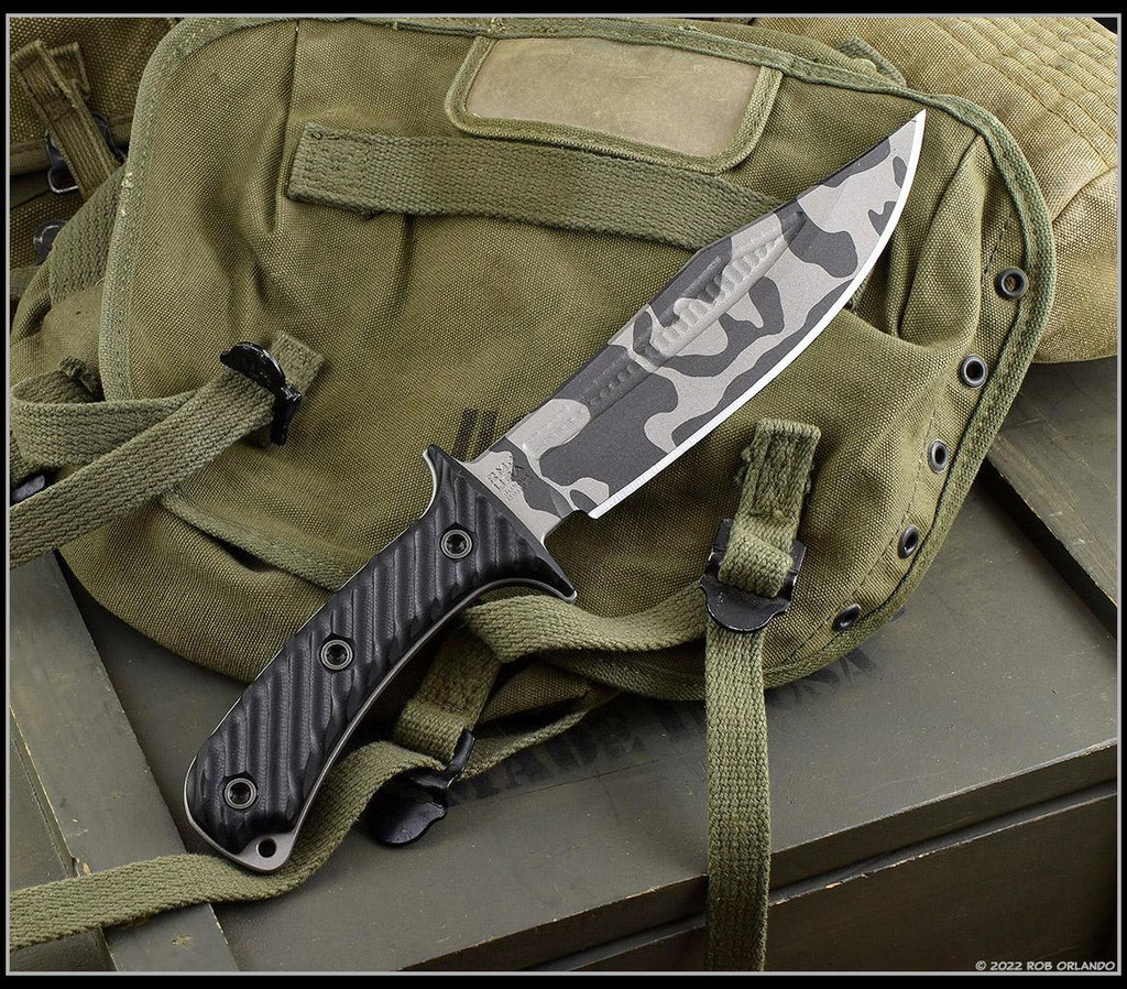 RMJ Tactical National Knives, LLC Exclusive 3V Syndicate Jungle Combat fixed blade knife - shown out of sheath obverse.  Urban Camo colored 3V steel plain edge blade.  Black G-10 handle.  Model K-JC-3V-UC.
For reference only.