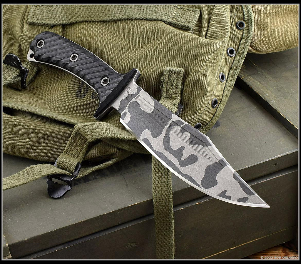 RMJ Tactical National Knives, LLC Exclusive 3V Syndicate Jungle Combat fixed blade knife - shown out of sheath obverse.  Urban Camo colored 3V steel plain edge blade.  Black G-10 handle.  Model K-JC-3V-UC.
For reference only.