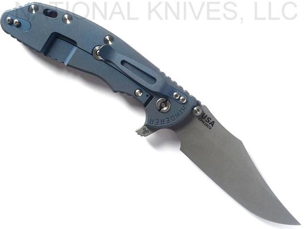 Rick Hinderer Knives XM-24 Bowie folding knife with thumb stud and flipper tab - shown open lock side.  Working Finish 20CV stainless steel plain edge blade.  Coyote G-10 handle with Battle Blue lock side.  Model KXM40BO.