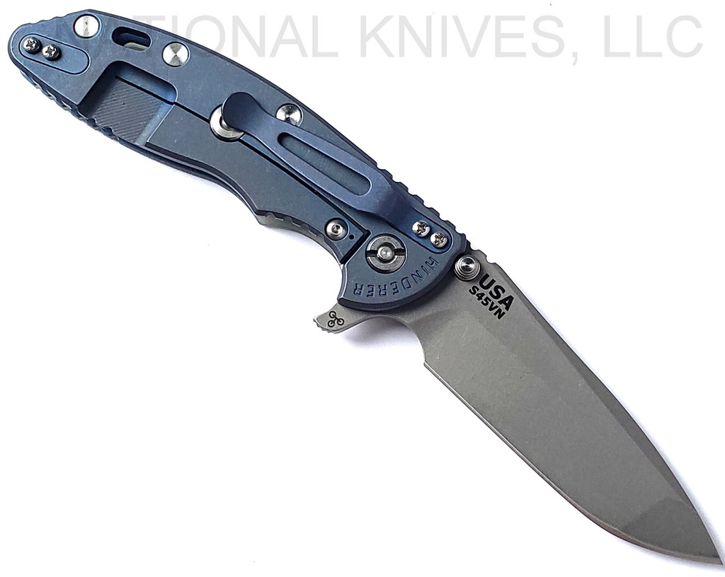 Rick Hinderer Knives XM-18 3.5" Spanto folding knife with thumb stud and flipper tab - shown open lock side.  Working Finish S45VN stainless steel plain edge blade.  Translucent Green G-10 handle with Battle Blue lock side.  Model KXM35SPA.