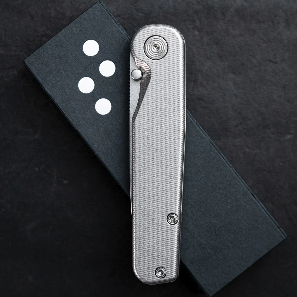 Tactile Knife Co Rockwall folding knife with a thumb stud - shown closed presentation side.  Stonewashed MagnaCut stainless steel plain edge blade.  Titanium handle.  Model 20-RT-MC01-TT01.