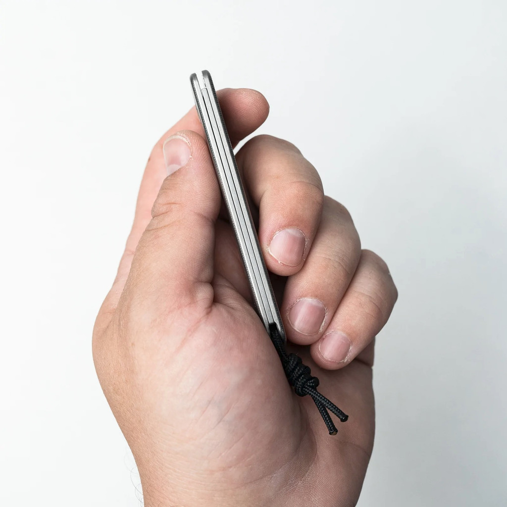 Tactile Knife Co Bexar slip joint folding knife with nail nick - shown closed in hand.  Stonewash MagnaCut stainless steel plain edge blade.  Titanium handle.  Model 20-BX-MC01-TT01.