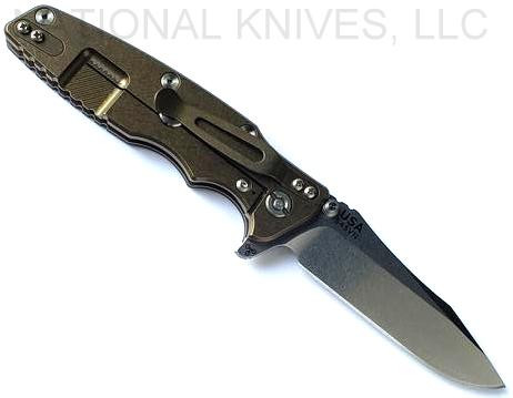 Rick Hinderer Knives Eklipse Spear Point folding knife with flipper tab and thumb stud - shown open lock side.  Stonewash S45VN stainless steel plain edge blade.  Black G-10 handle with stonewash bronze lock side.  Model KEK35SPE.
