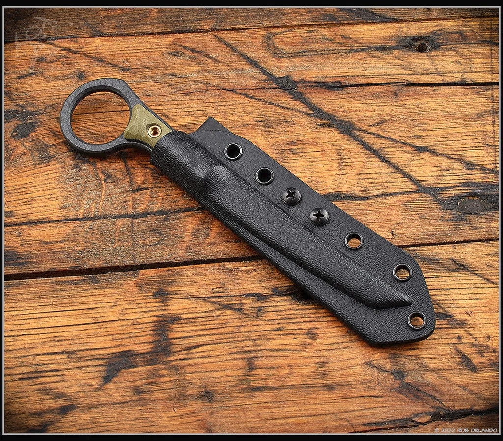 RMJ Tactical Stabby Guy multitool - shown in sheath obverse.  Cobalt Cerakote CPM-3V steel construction with OD green G-10.