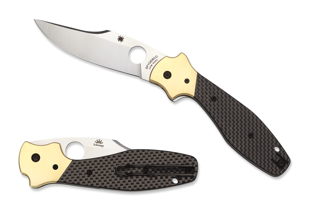 Spyderco Schempp Bowie folding knife with thumb hole - shown open presentation side and closed pocket clip side.  Satin S30V stainless steel plain edge blade.  Black carbon fiber and G-10 laminate handle with brass bolster.  Model C190CFP.
For reference only.