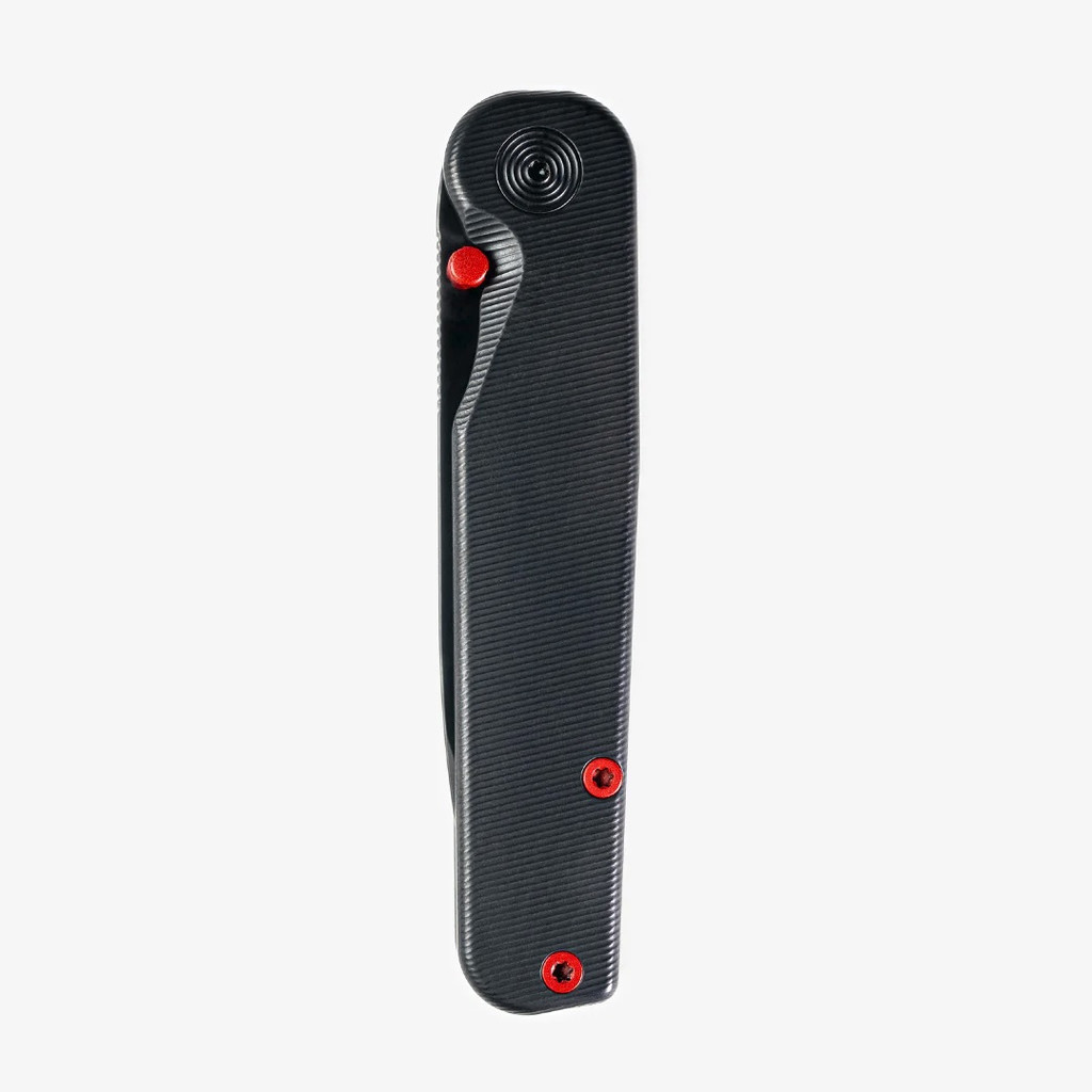 Tactile Knife Co Seasonal Release Stealth folding knife with thumb stud - shown closed presentation side.  Black MagnaCut stainless steel plain edge blade.  Stealth themed titanium handle.