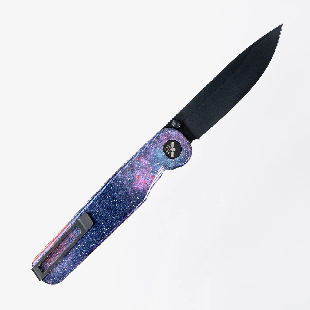 Tactile Knife Co Seasonal Release Deep Space Rockwall folding knife with thumb stud - shown open pocket clip side.  Black MagnaCut stainless steel plain edge blade.  Deep Space themed titanium handle.
For reference only.