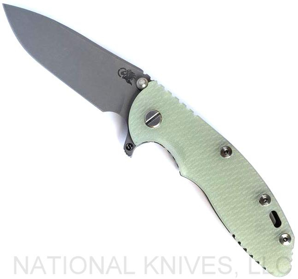 Rick Hinderer Knives Skinny XM-18 3.5" Slicer folding knife with thumb stud and flipper tab - shown open presentation side.  Working Finish MagnaCut stainless steel plain edge blade.  Translucent Green G-10 handle with Working Finish lock side.  Model KXM35SKSL.