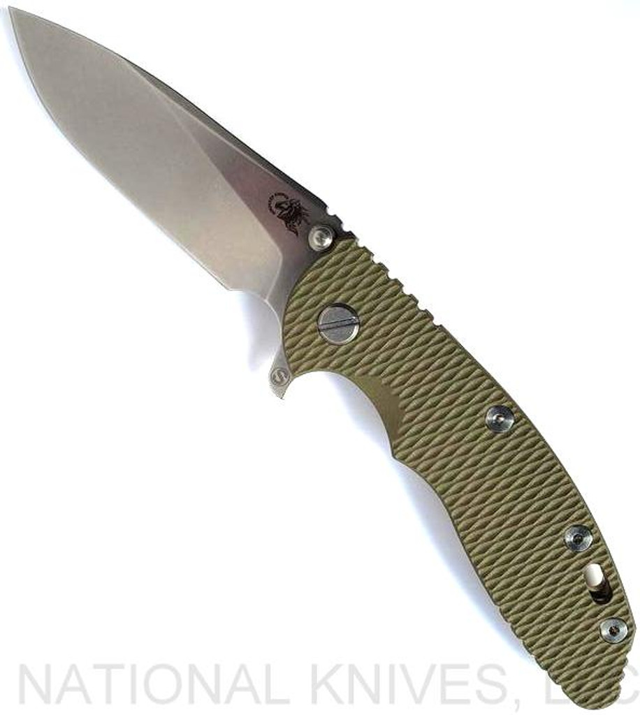 Rick Hinderer Knives Skinny XM-18 3.5" Slicer folding knife with thumb stud and flipper tab - shown open presentation side.  Stonewash MagnaCut stainless steel plain edge blade.  OD green G-10 handle with stonewash bronze lock side.  Model KXM35SKSL.