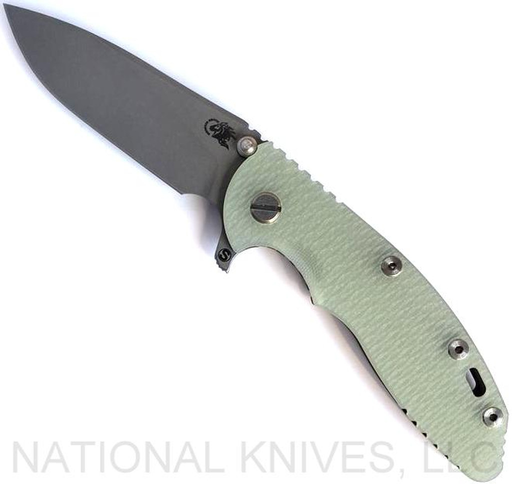 Rick Hinderer Knives Skinny XM-18 3.5" Slicer folding knife with thumb stud and flipper tab - shown open presentation side.  Working Finish MagnaCut stainless steel plain edge blade.  Translucent Green G-10 handle with Battle Bronze lock side.  Model KXM35SKSL.