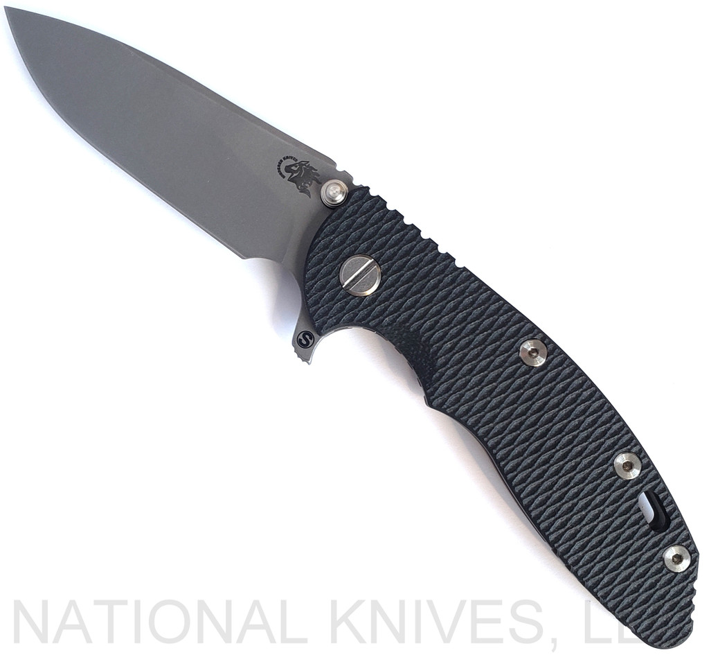 Rick Hinderer Knives Skinny XM-18 3.5" Slicer folding knife with thumb stud and flipper tab - shown open presentation side.  Working Finish MagnaCut stainless steel plain edge blade.  Black G-10 handle with Battle Bronze lock side.  Model KXM35SKSL.