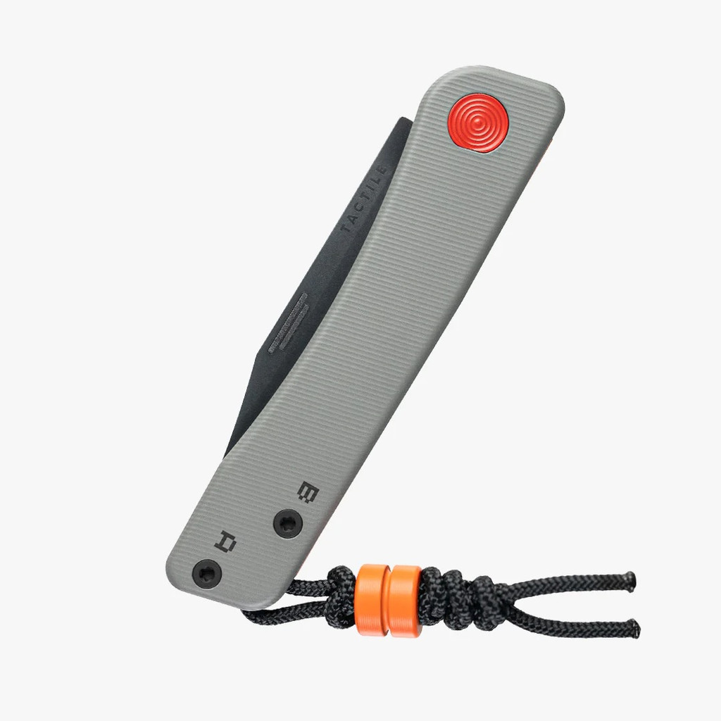 Tactile Knife Co 8-Bit Bexar limited edition slip joint knife with nail nick - shown closed logo side.  Black MagnaCut stainless steel plain edge blade.  Gray and orange titanium handle.  Model 20-BX-MCDL-TTDL
For reference only.