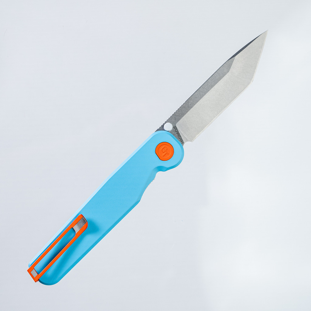 Tactile Knife Co Seasonal Release GT Rockwall folding knife with a thumb stud - shown open pocket clip side.  Stonewashed MagnaCut stainless steel plain edge Tanto blade.  Blue coated titanium handle.  Model 20-RT-MCTN-TTGT.