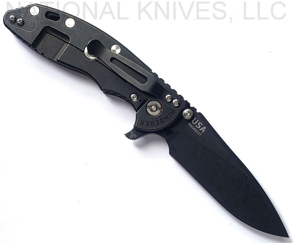 Rick Hinderer Knives Skinny XM-18 3.5" Slicer folding knife with thumb stud and flipper tab - shown open lock side.  Battle Black MagnaCut stainless steel plain edge blade.  OD green G-10 handle with Battle Black lock side.  Model KXM35SKSLDLC.