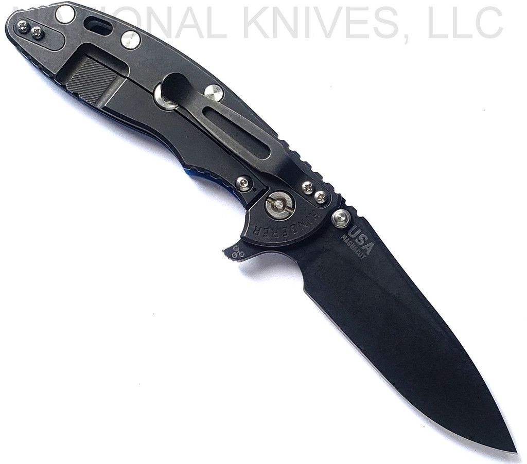Rick Hinderer Knives Skinny XM-18 3.5" Slicer folding knife with thumb stud and flipper tab - shown open lock side.  Battle Black MagnaCut stainless steel plain edge blade.  Blue G-10 handle with Battle Black lock side.  Model KXM35SKSLDLC.
