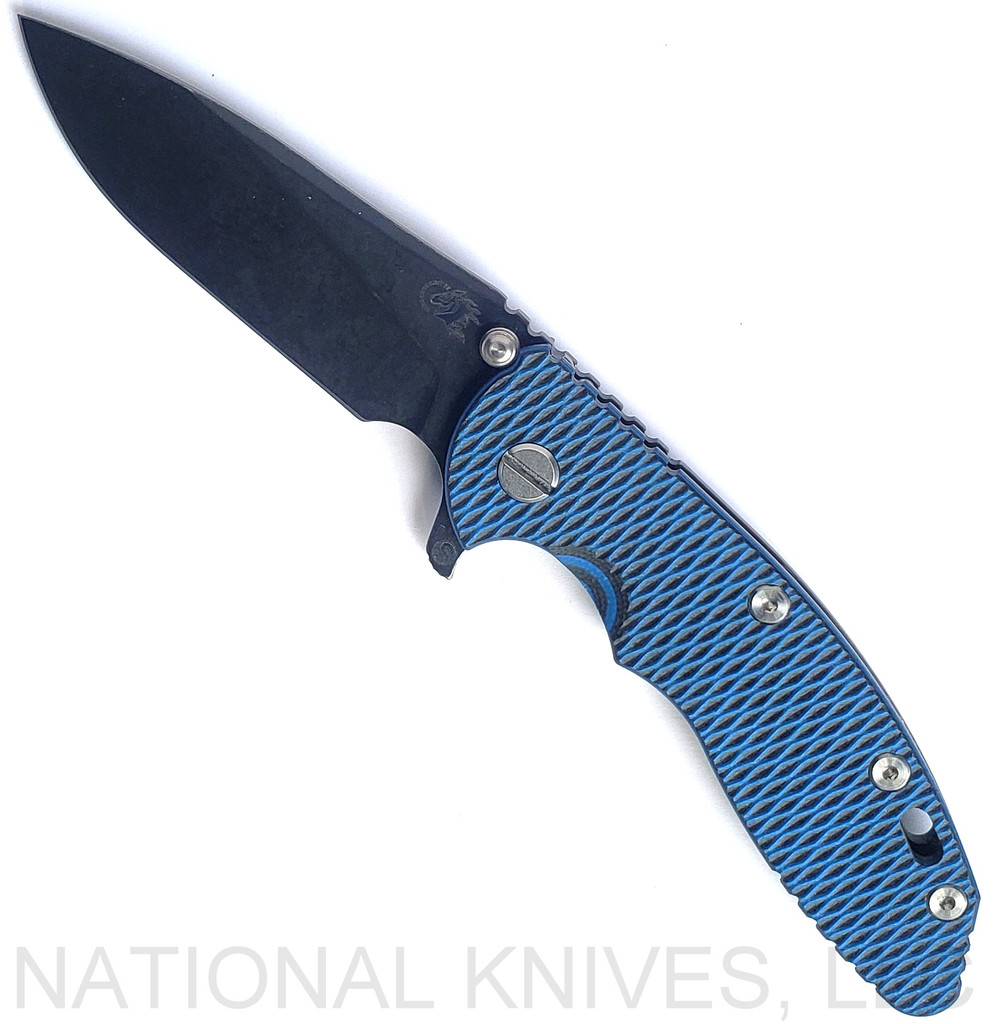 Rick Hinderer Knives Skinny XM-18 3.5" Slicer folding knife with thumb stud and flipper tab - shown open presentation side.  Battle Black MagnaCut stainless steel plain edge blade.  Blue - black G-10 handle with Battle Black lock side.  Model KXM35SKSLDLC.
