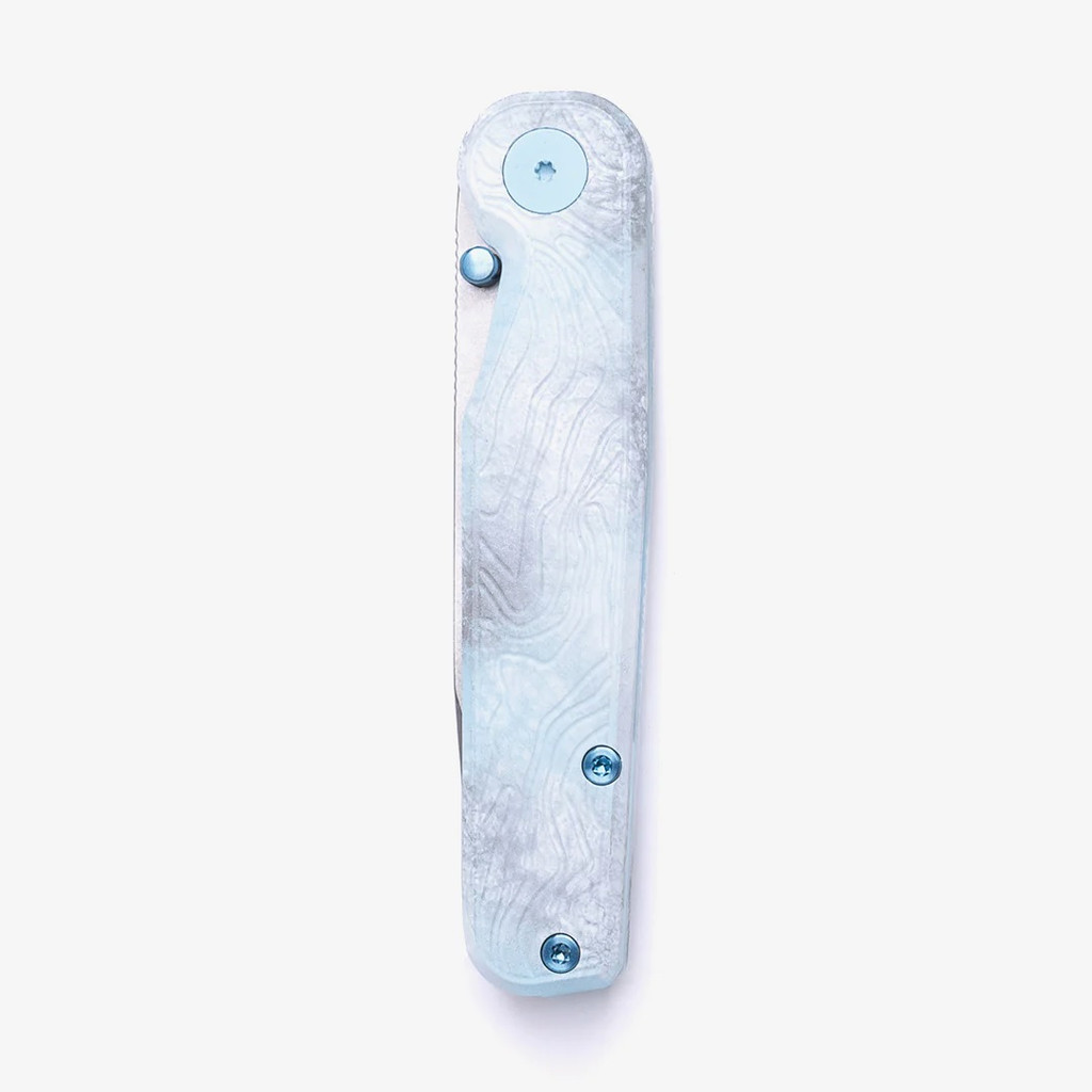 Tactile Knife Co Seasonal Release Icefall Rockwall folding knife with a thumb stud - shown closed presentation side.  Stonewashed MagnaCut stainless steel plain edge Tanto blade.  Multi colored coated titanium handle.  Model 20-RT-MCTN-ICE.
For reference only.