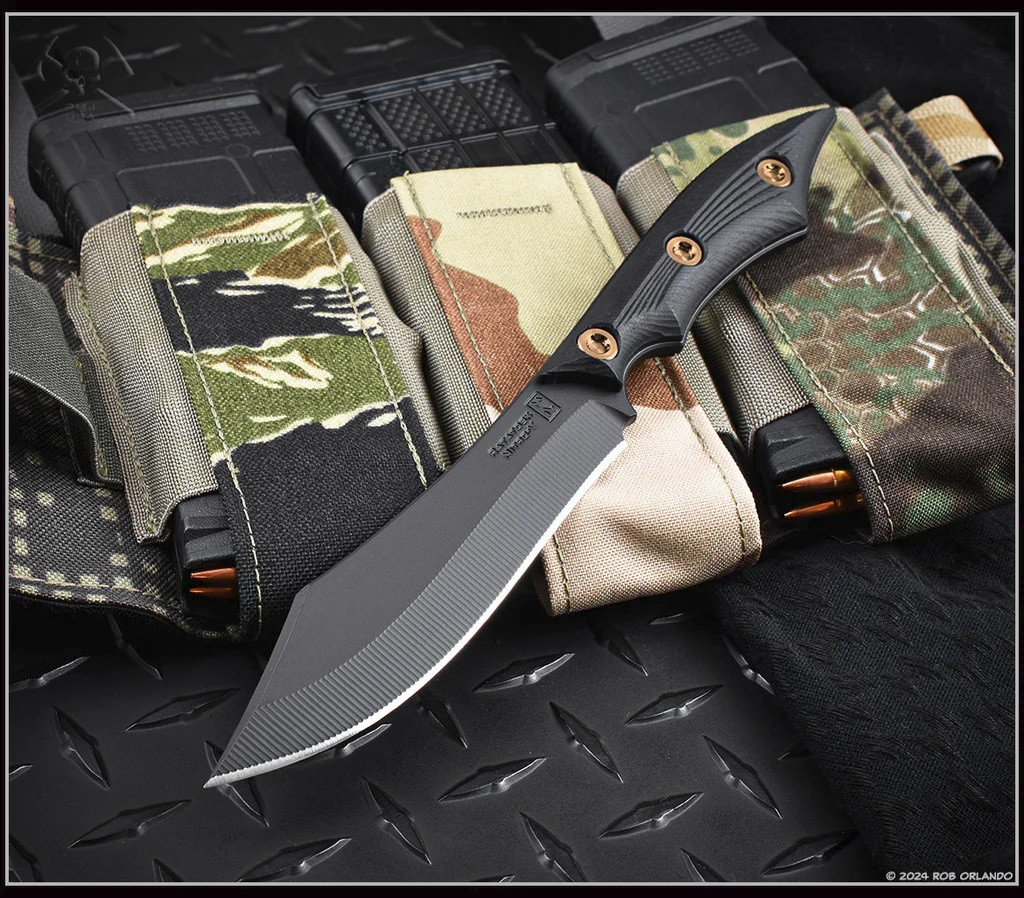 RMJ Tactical Ratatosk fixed blade knife with bronze hardware installed - shown out of sheath reverse.  Graphite Black Cerakote Nitro-V stainless steel plain edge blade.  Black Micarta handle.  Model K-RT-GB-LM-BK.
