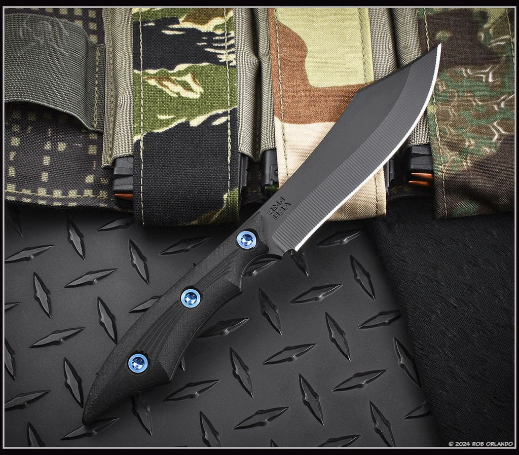 RMJ Tactical Ratatosk fixed blade knife with blue hardware installed - shown out of sheath obverse.  Graphite Black Cerakote Nitro-V stainless steel plain edge blade.  Black Micarta handle.  Model K-RT-GB-LM-BK.