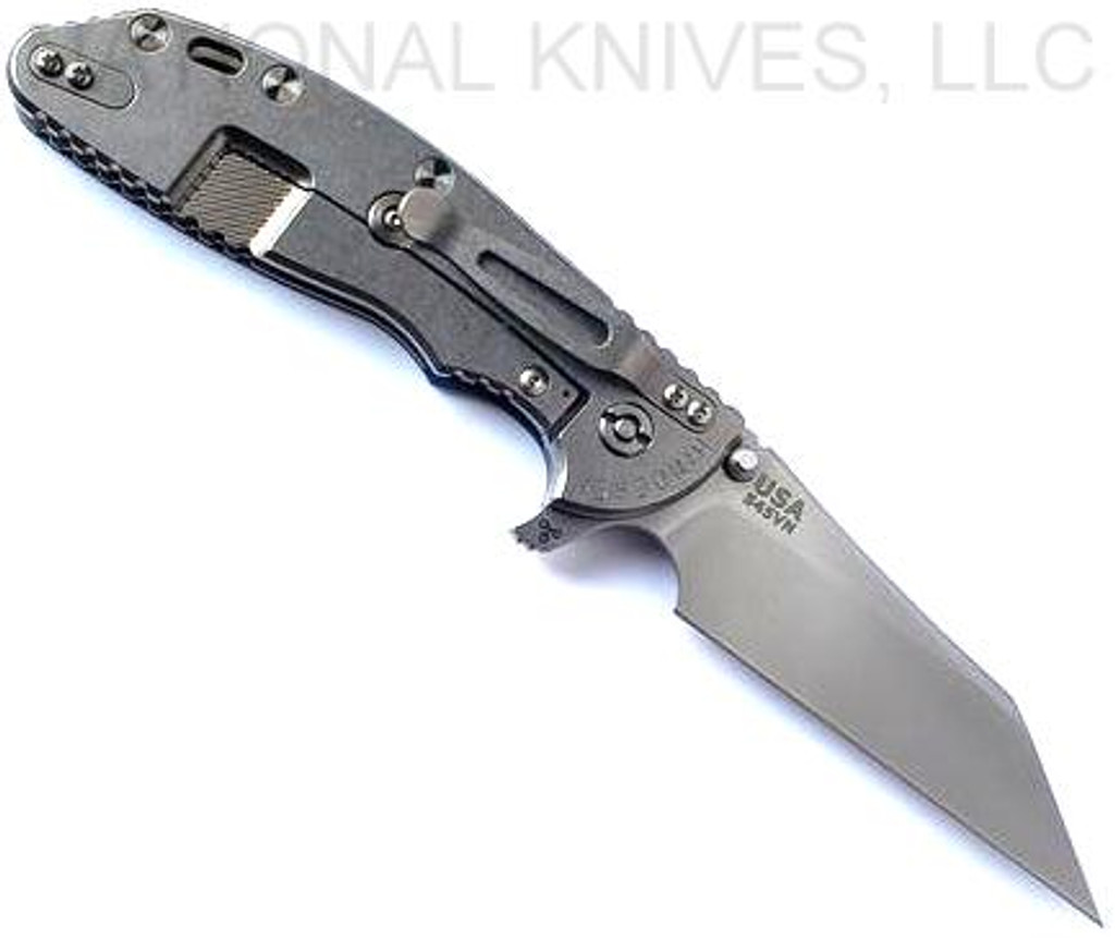Rick Hinderer Knives Skinny XM-24 Wharncliffe folding knife with thumb stud and flipper tab - shown open lock side.  Stonewash S45VN stainless steel plain edge blade.  Blue - black G-10 handle with stonewash lock side.  Model KXM40SKWC.