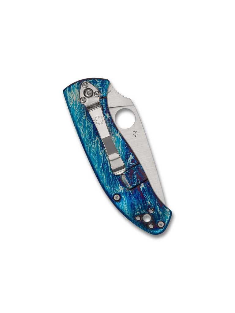 Spyderco Tenacious folding knife with thumb hole - shown closed pocket clip side.  Satin D2 steel plain edge blade.  Disarray titanium handle.  Model C122TIBLD2P.