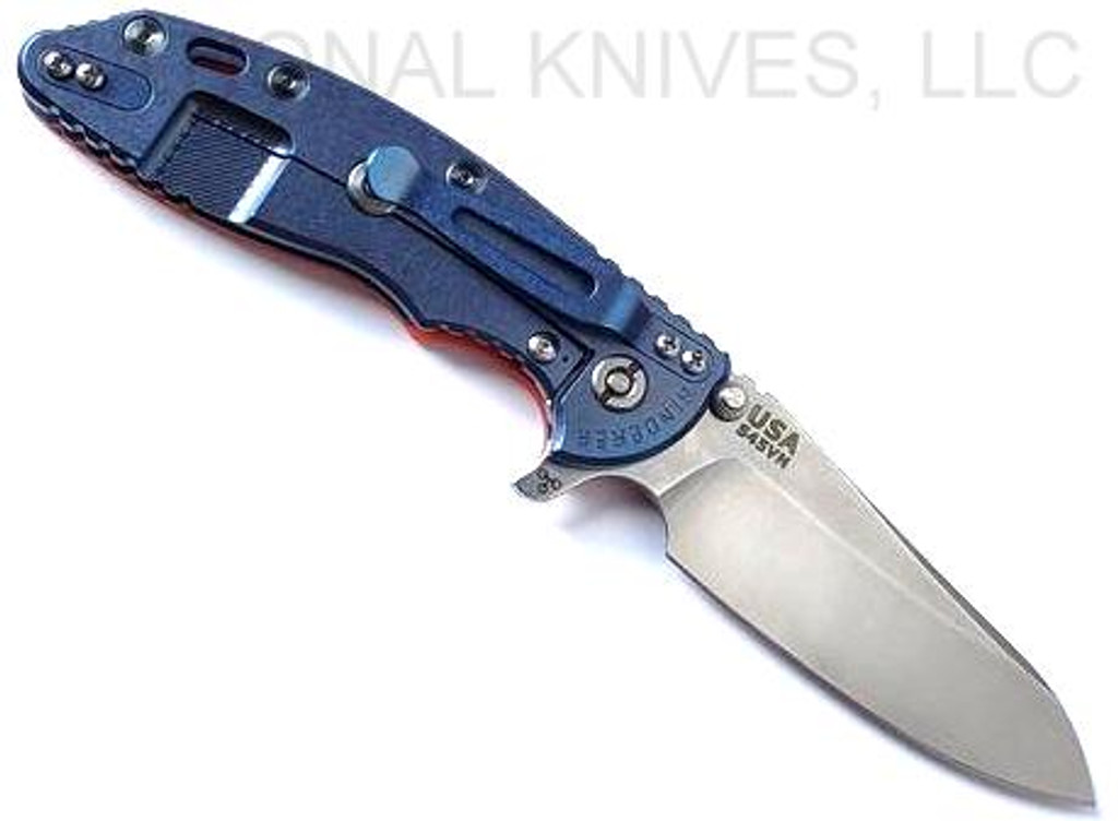 Rick Hinderer Knives XM-18 3.5" Sheepsfoot folding knife with thumb stud and flipper tab - shown open lock side.  Stonewash S45VN stainless steel plain edge blade.  Orange G-10 handle with stonewash blue lock side.  Model KXM35SHF.