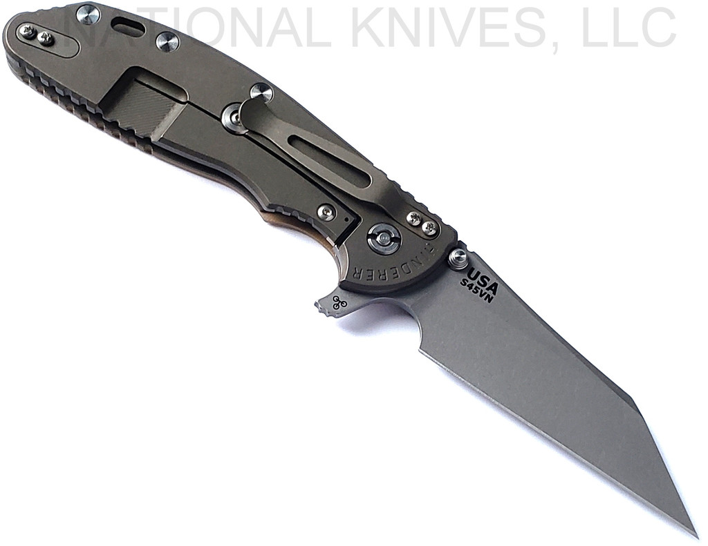 Rick Hinderer Knives Skinny XM-24 Wharncliffe folding knife with thumb stud and flipper tab - shown open lock side.  Working Finish S45VN stainless steel plain edge blade.  Coyote G-10 handle with Battle Bronze lock side.  Model KXM40SKWC.