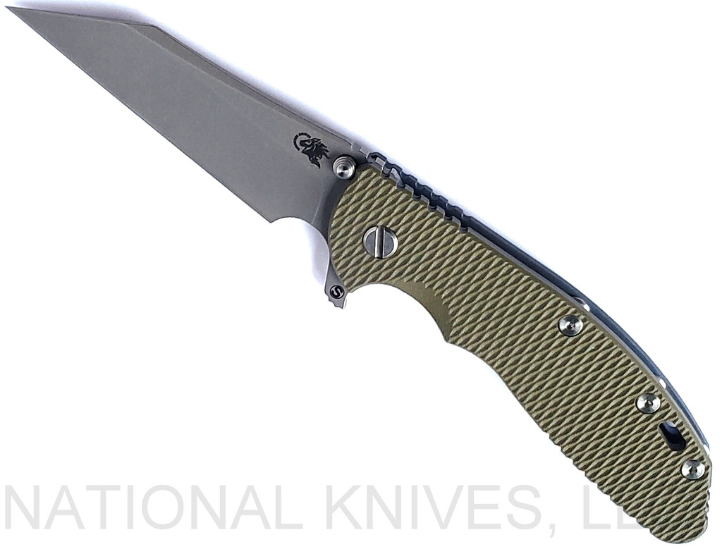 Rick Hinderer Knives Skinny XM-24 Wharncliffe folding knife with thumb stud and flipper tab - shown open presentation side.  Working Finish S45VN stainless steel plain edge blade.  OD green G-10 handle with Battle Blue lock side.  Model KXM40SKWC.