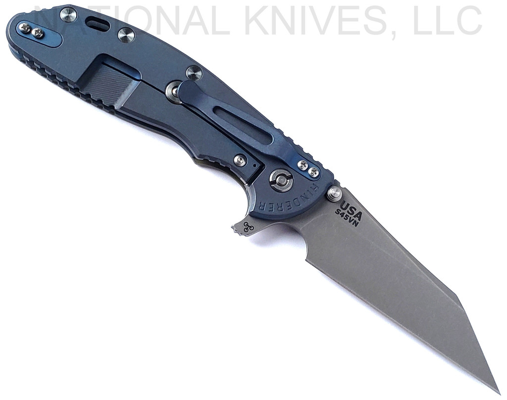 Rick Hinderer Knives Skinny XM-24 Wharncliffe folding knife with thumb stud and flipper tab - shown open lock side.  Working Finish S45VN stainless steel plain edge blade.  OD green G-10 handle with Battle Blue lock side.  Model KXM40SKWC.