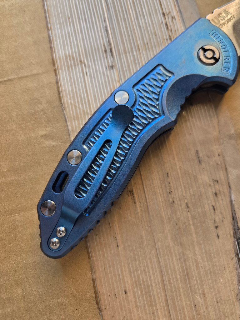 USED Rick Hinderer Knives XM-18 Automatic Spearpoint knife with push button - close up of pocket clip side handle shown.  Stonewash 20CV stainless steel plain edge blade.  Anodized blue titanium handle. 