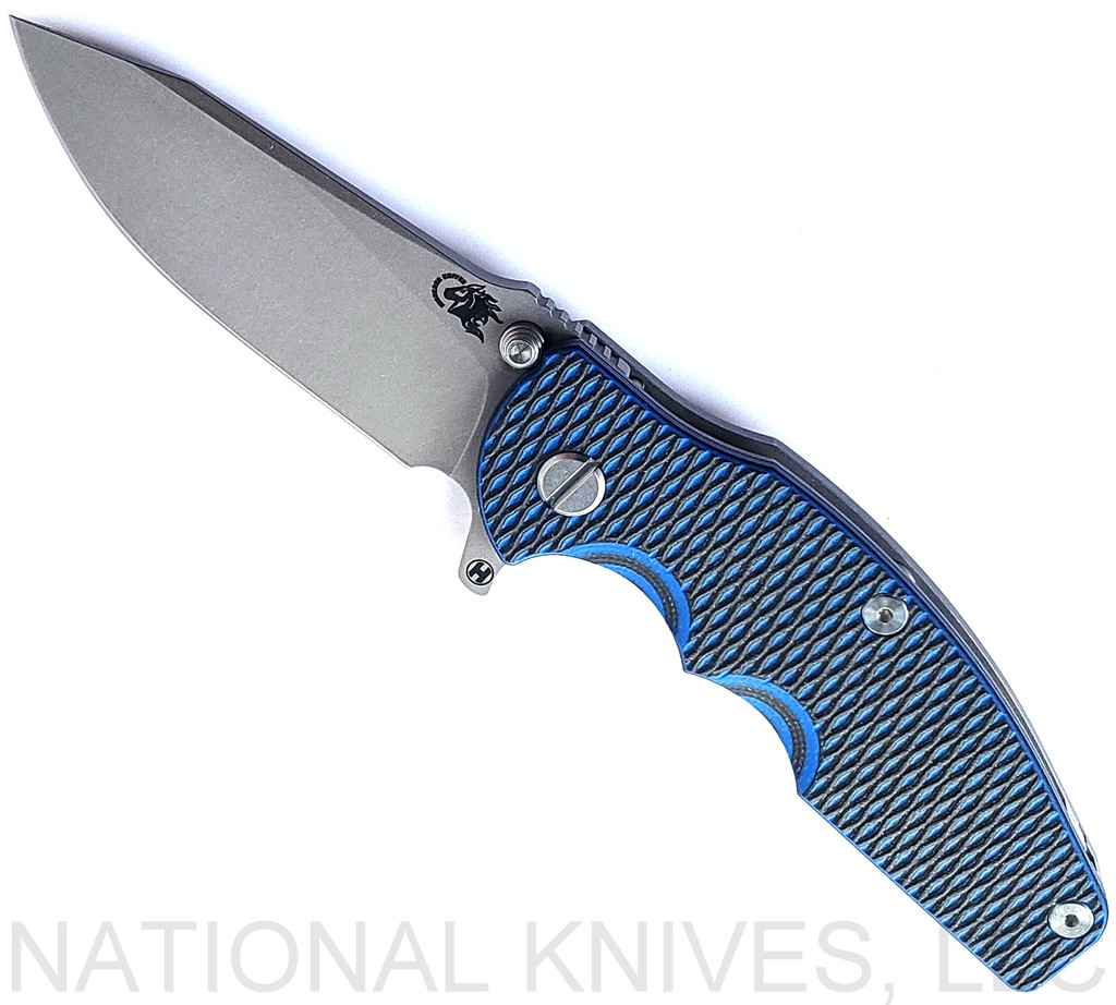 Rick Hinderer Knives Jurassic Hollow Grind Slicer folding knife with flipper tab - shown open presentation side.  Working Finish MagnaCut stainless steel plain edge blade.  Blue - Black G-10 handle scale with Working Finish titanium lock side.  Model KJURSLHO.