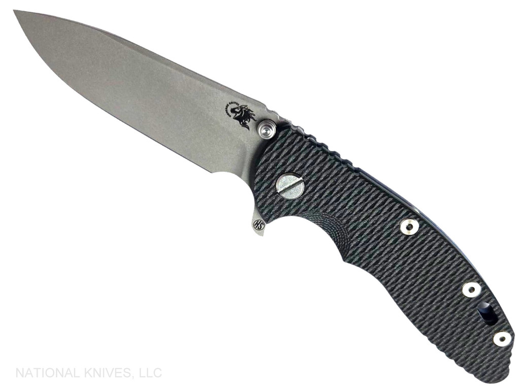 Rick Hinderer Knives XM-18 Skinny Slicer with thumb stud and flipper tab - shown open presentation side.  Working Finish Magnacut stainless steel, hollow ground, plain edge blade.  Black G-10 handle with Battle Blue lock side. 