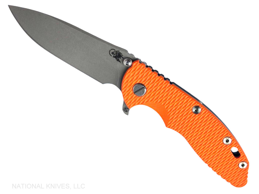 Rick Hinderer Knives XM-18 Skinny Slicer with thumb stud and flipper tab - shown open presentation side.  Working Finish Magnacut stainless steel, hollow ground, plain edge blade.  Orange G-10 handle with Battle Blue lock side. 